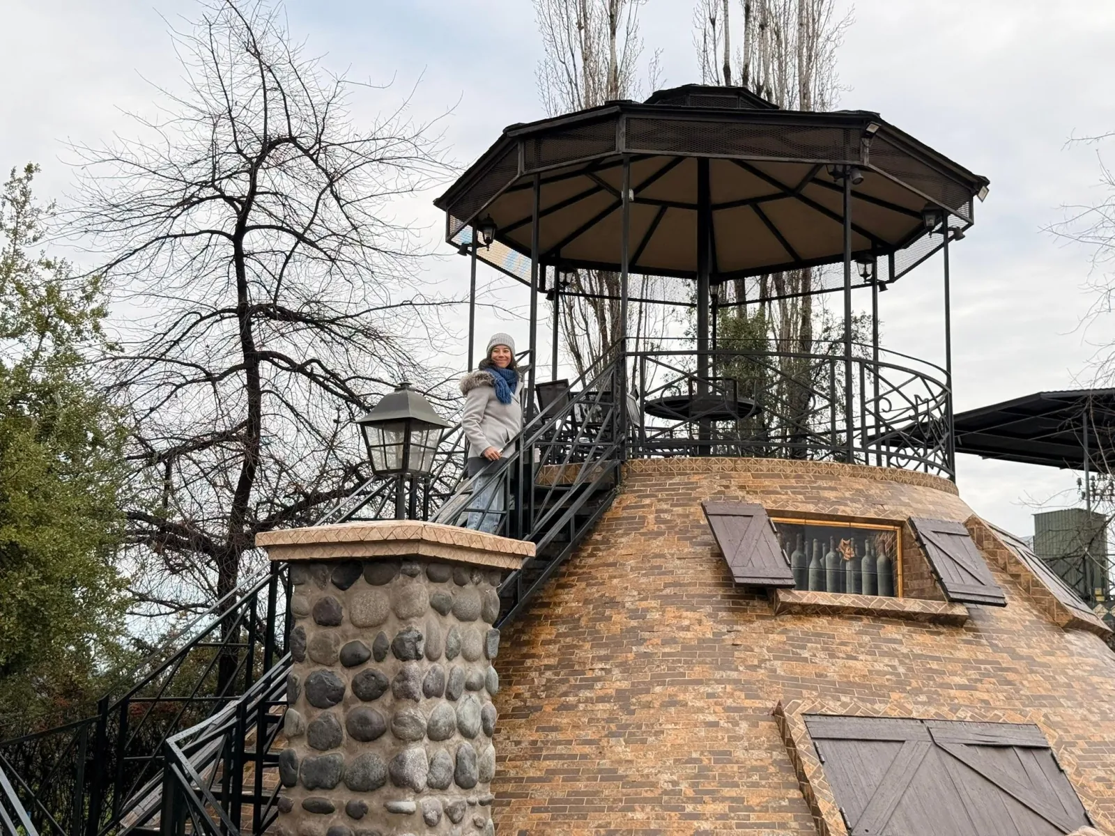 Visitor on the iron staircase of a brick tower topped by a gazebo
