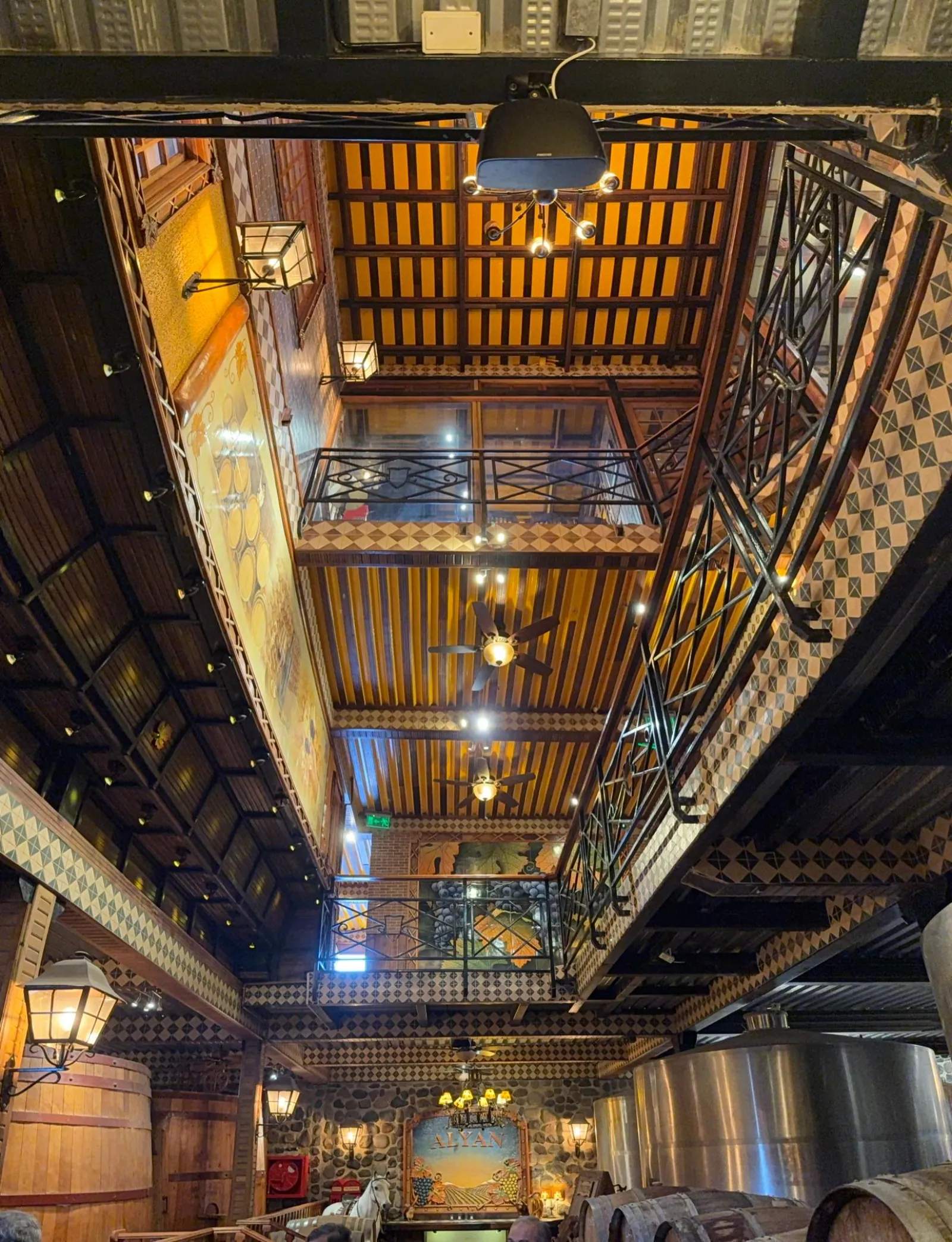 Looking up at the tiled, multi-level atrium inside the Alyan winery hall