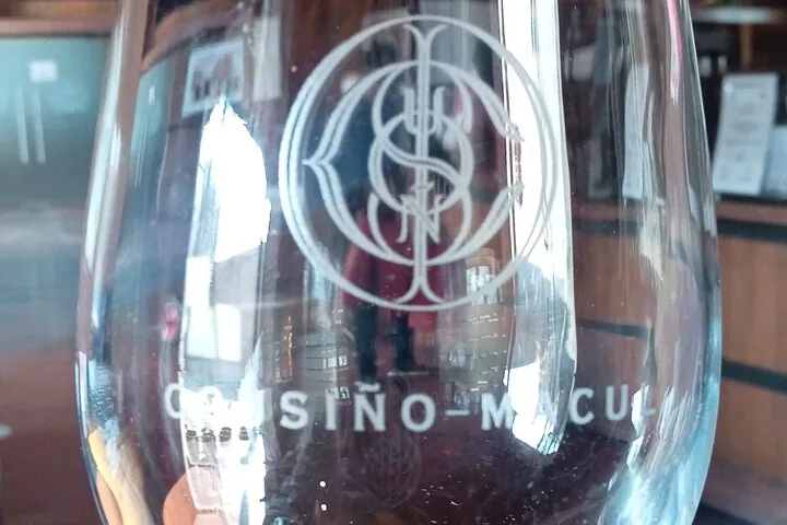 Close-up of an engraved Cousiño Macul tasting glass in the wine shop