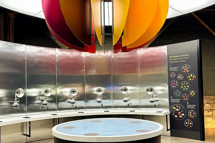 Aroma exhibit with steel funnels and glass flasks under colorful petals