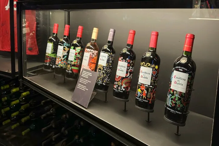 Row of decorated Casillero del Diablo bottles in a display case